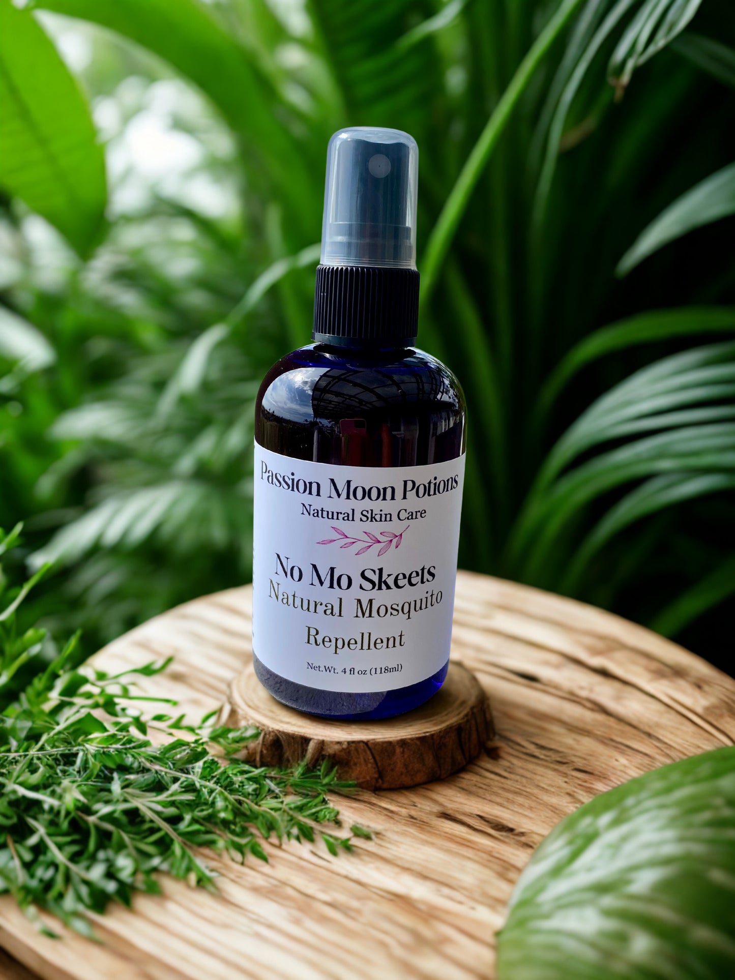 Bottle of 'No Mo Skeets' natural mosquito repellent on a wooden surface with greenery in the background