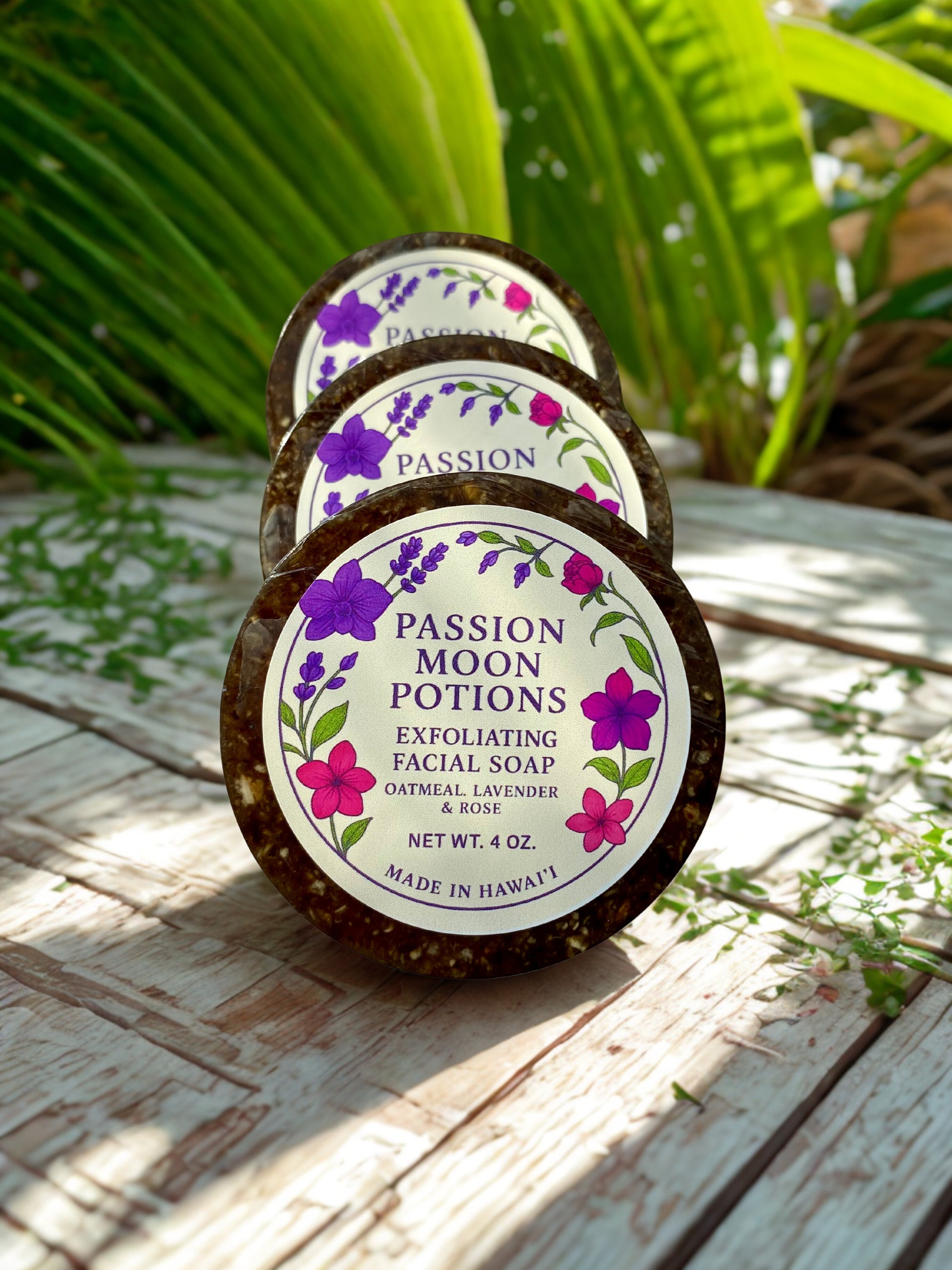 Passion Moon Potions exfoliating facial soap on a wooden surface with greenery in the background