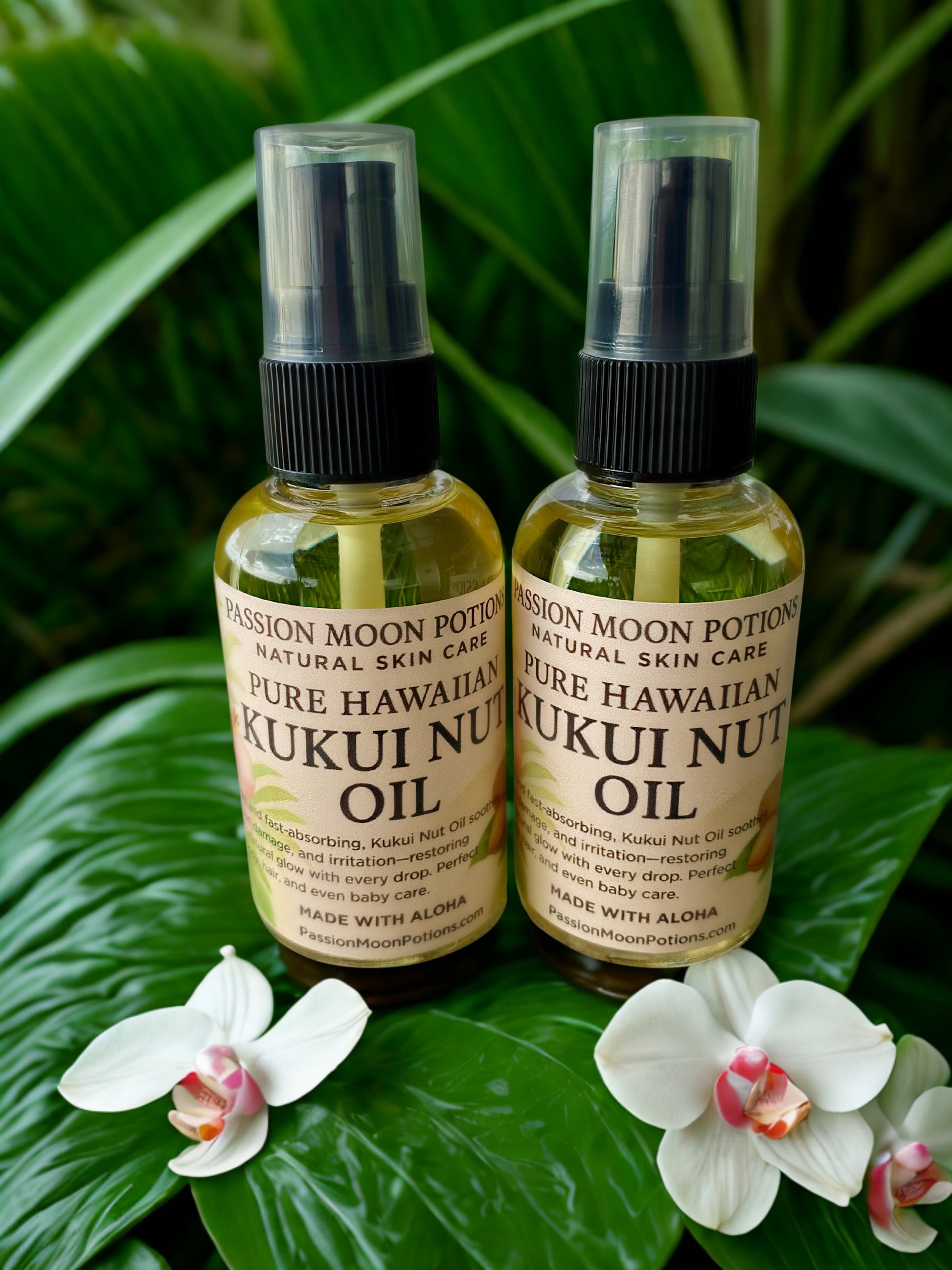 Two bottles of Pure Hawaiian Kukui Nut Oil with orchids on a leafy background